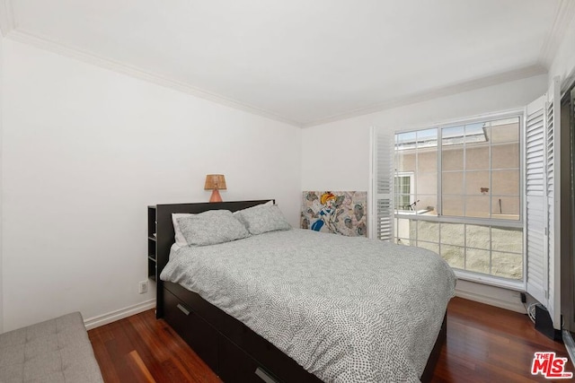 bedroom featuring ornamental molding and dark hardwood / wood-style flooring