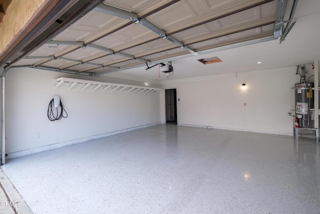 garage with a garage door opener and strapped water heater