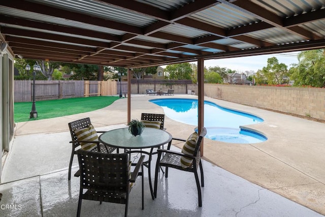 view of swimming pool with a jacuzzi and a patio