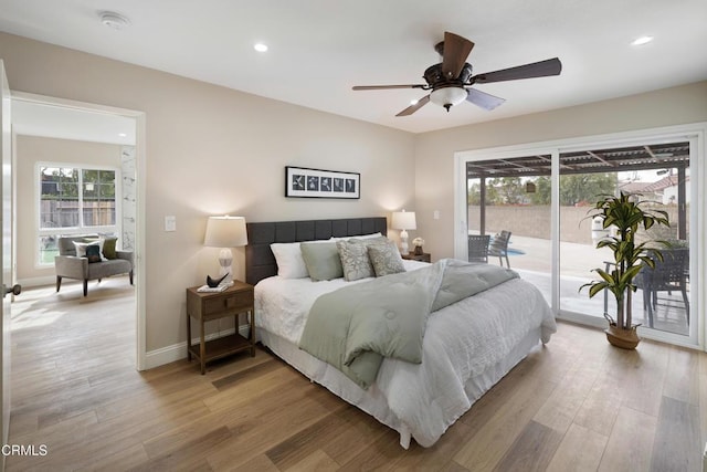 bedroom with hardwood / wood-style flooring, access to outside, and ceiling fan