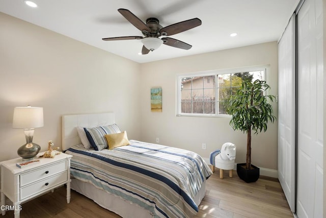 bedroom with light wood-type flooring and ceiling fan