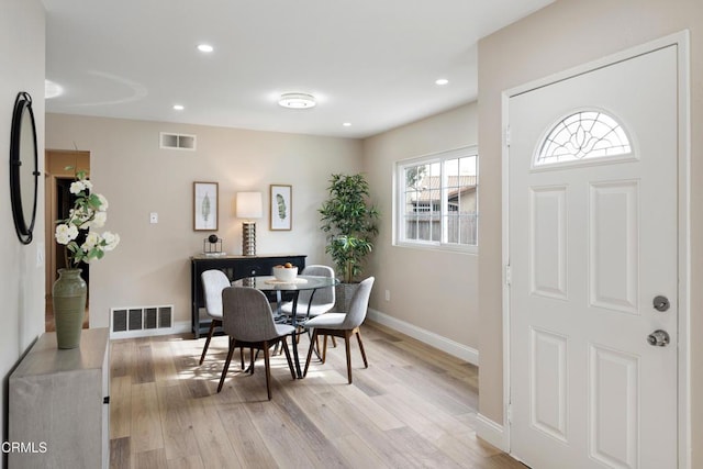 dining space featuring light wood-type flooring