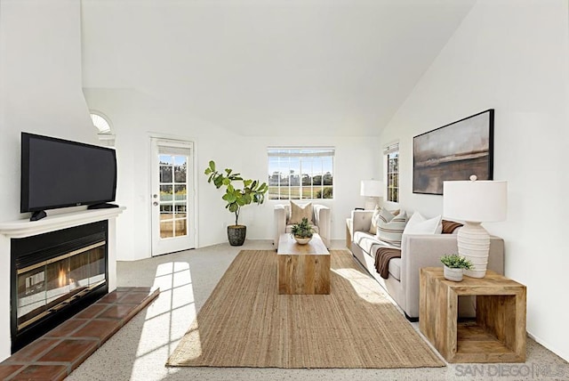 living room featuring a fireplace and vaulted ceiling