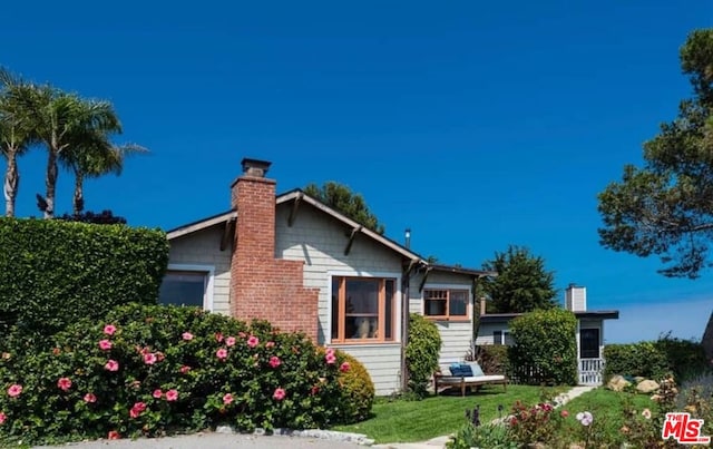 back of house with a lawn