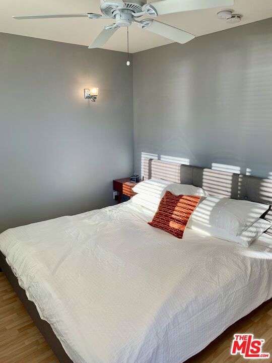 bedroom with hardwood / wood-style flooring and ceiling fan