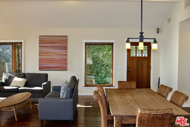 dining space featuring lofted ceiling and dark hardwood / wood-style flooring