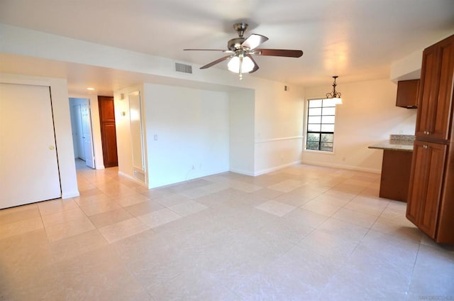 interior space with ceiling fan with notable chandelier