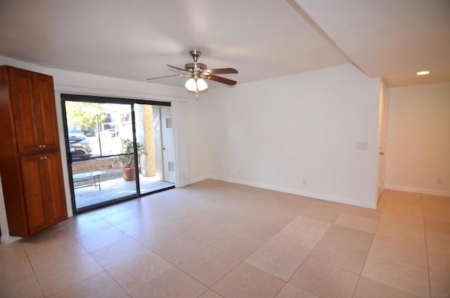 empty room with light tile patterned floors and ceiling fan