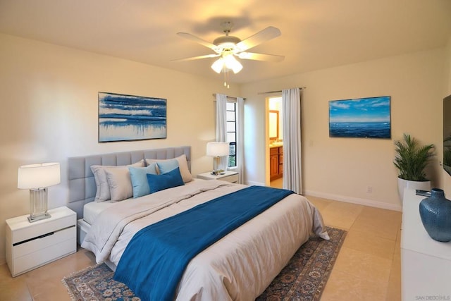 bedroom featuring light tile patterned flooring, ceiling fan, and ensuite bath