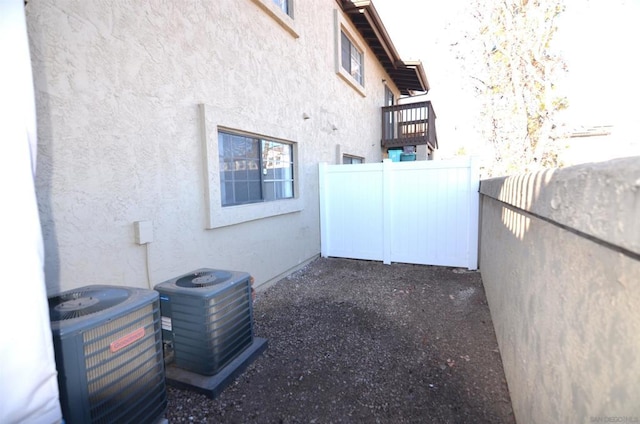 view of side of home with central air condition unit