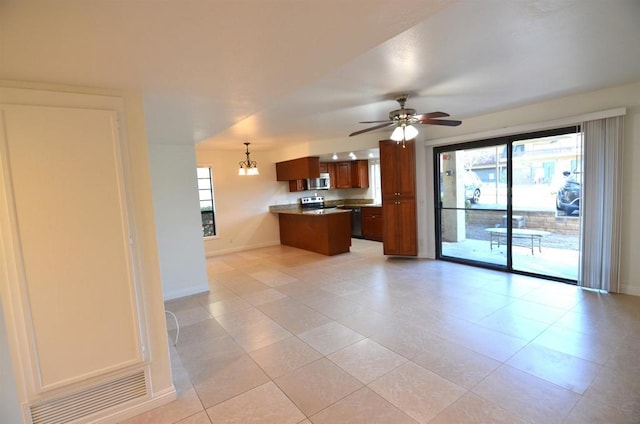 kitchen featuring decorative light fixtures, light tile patterned floors, kitchen peninsula, stainless steel appliances, and ceiling fan with notable chandelier