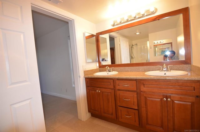 bathroom with vanity, tile patterned floors, and walk in shower