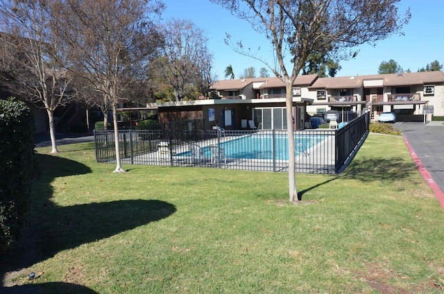 view of pool with a yard