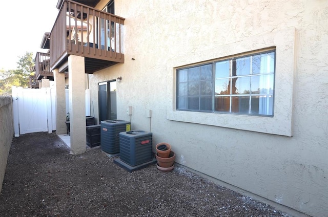 view of side of property featuring a balcony and central air condition unit