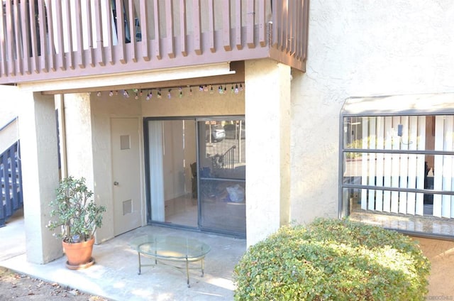 doorway to property featuring a balcony and a patio area