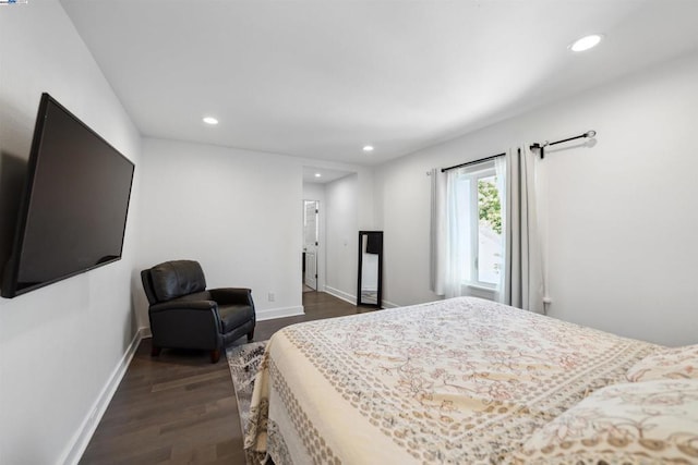 bedroom with dark hardwood / wood-style floors