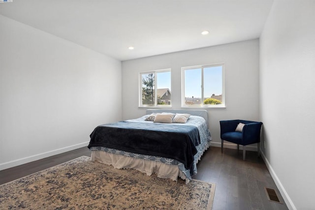 bedroom with dark wood-type flooring