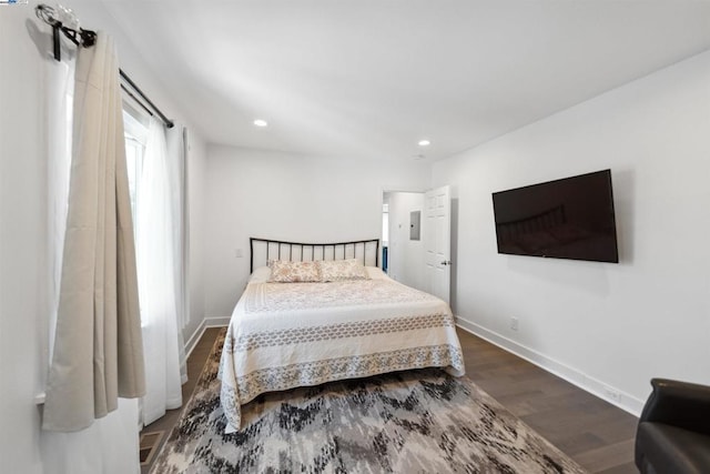 bedroom with dark hardwood / wood-style flooring