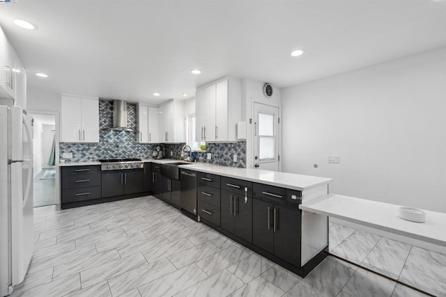 kitchen with wall chimney exhaust hood, white cabinetry, white refrigerator, dishwasher, and stainless steel gas stovetop