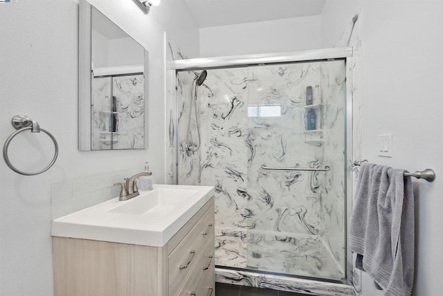 bathroom featuring vanity and an enclosed shower