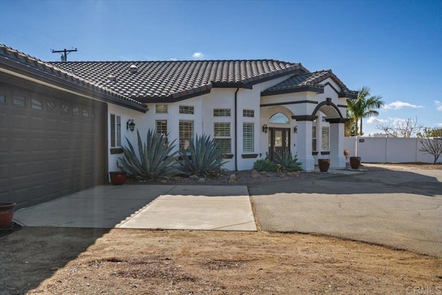 mediterranean / spanish house with a garage