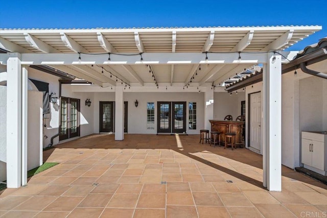 view of patio featuring a bar and french doors