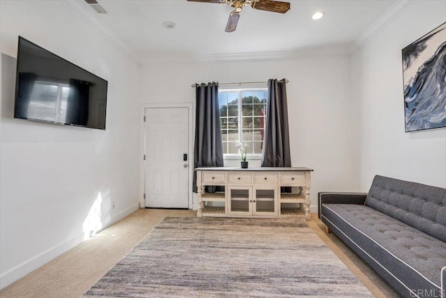 carpeted living room with crown molding and ceiling fan