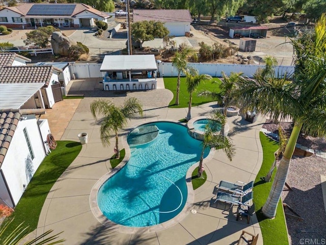 view of swimming pool featuring a patio area and an in ground hot tub