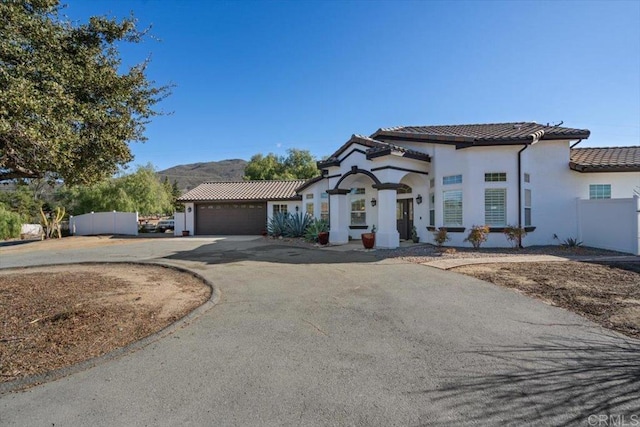 mediterranean / spanish-style house featuring a garage and a mountain view