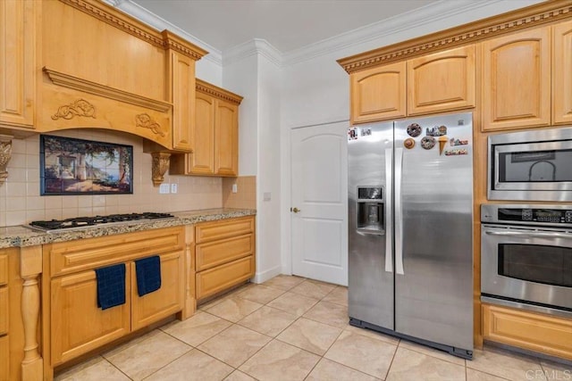 kitchen with ornamental molding, appliances with stainless steel finishes, decorative backsplash, and light tile patterned floors