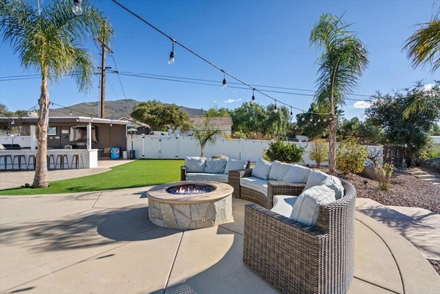 view of patio / terrace with a bar and an outdoor living space with a fire pit