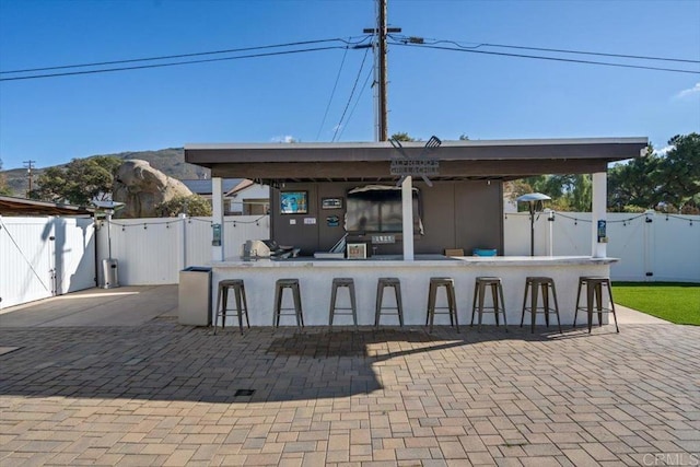 view of patio / terrace featuring an outdoor bar