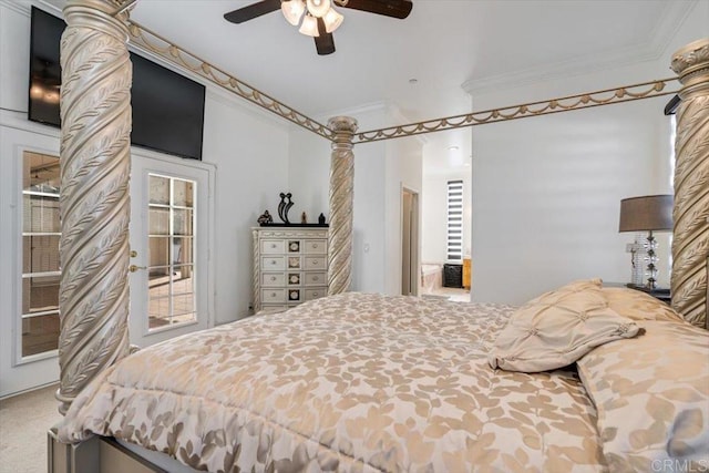 carpeted bedroom featuring crown molding, ceiling fan, and ornate columns