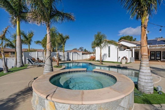 view of pool with an in ground hot tub and a patio