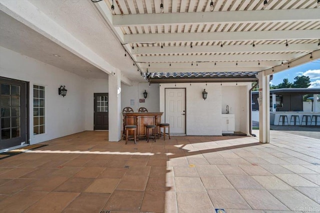 view of patio with an outdoor bar