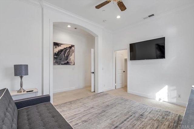 interior space with crown molding, light colored carpet, and ceiling fan