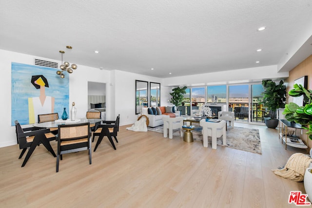 dining area featuring a textured ceiling and light hardwood / wood-style floors