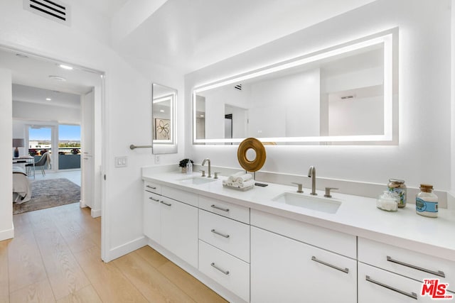 bathroom featuring hardwood / wood-style flooring and vanity