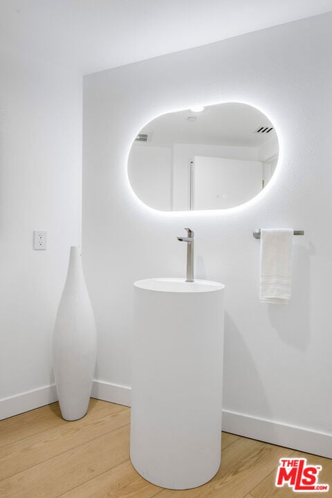 bathroom with hardwood / wood-style floors