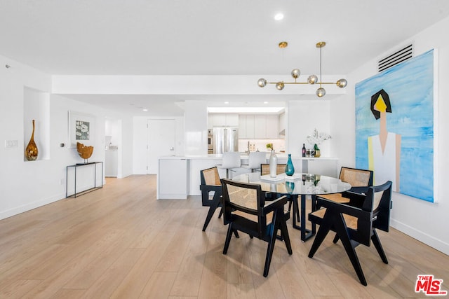 dining space with light hardwood / wood-style flooring