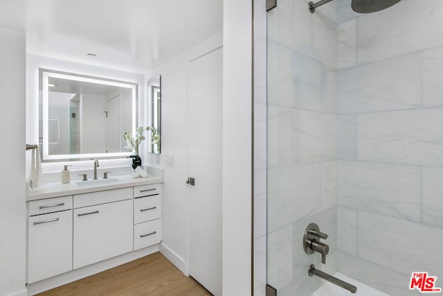 bathroom with vanity, wood-type flooring, and tub / shower combination