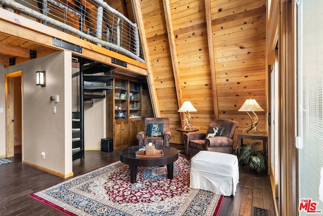 living area with beamed ceiling, wood ceiling, and dark hardwood / wood-style flooring