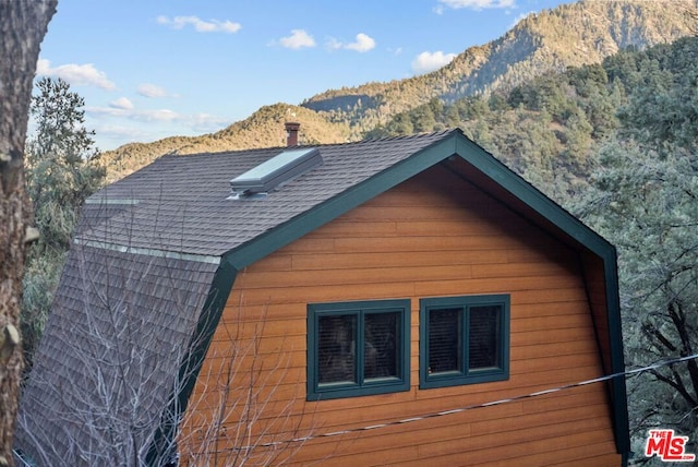 view of side of home featuring a mountain view