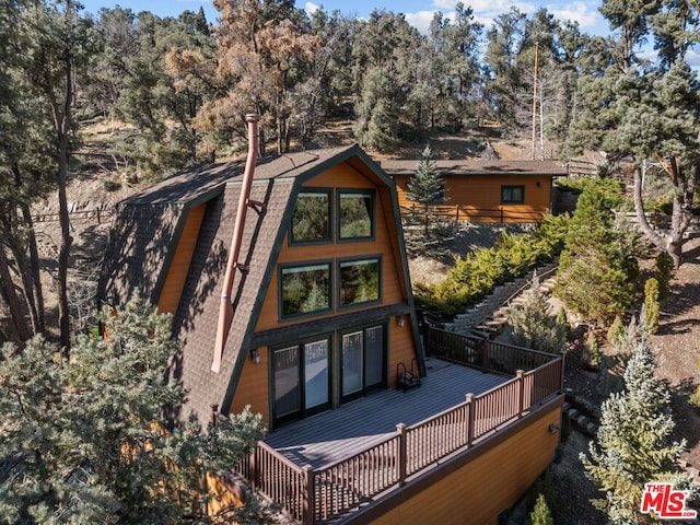 back of property featuring a wooden deck