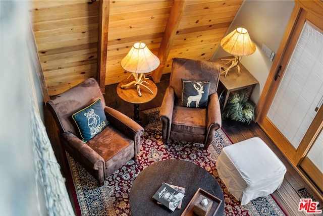 sitting room with wood ceiling, beam ceiling, and hardwood / wood-style flooring