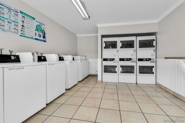 laundry room featuring crown molding, stacked washer and dryer, light tile patterned floors, and washing machine and clothes dryer