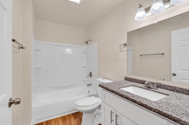 full bathroom featuring vanity, hardwood / wood-style floors,  shower combination, and toilet