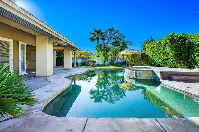 view of swimming pool with an in ground hot tub and a patio