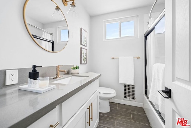 full bathroom with vanity, shower / bath combination with curtain, and toilet