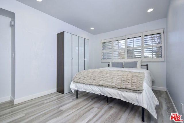 bedroom with light hardwood / wood-style floors